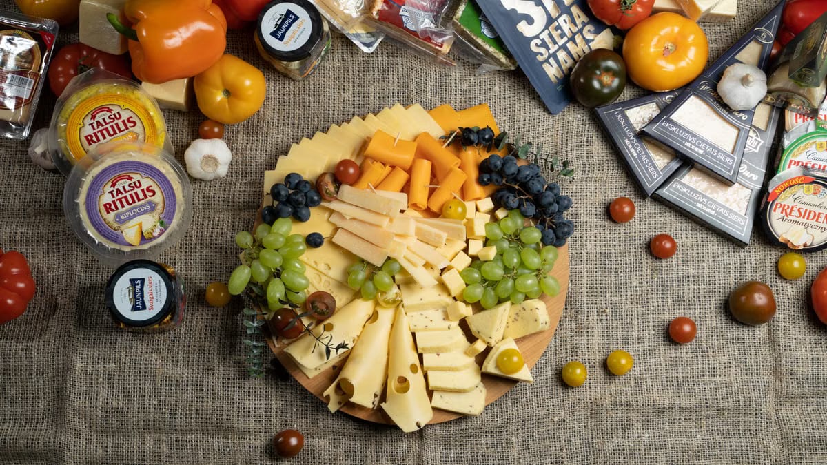 Colorful charcuterie board with assorted cheeses and fresh fruits.